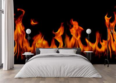 On fire flames at the black background, Burning red hot sparks rise, Fiery orange glowing flying particles Wall mural