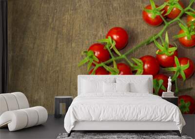 Fresh cherry tomato on rustic wood table. Top view cherry tomato for background or wallpaper. Prepare fresh cherry tomato for home cooking look so delicious. Top view with copy space in vintage tone. Wall mural