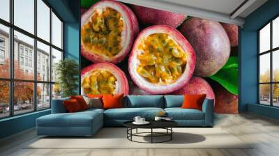 Fresh passion fruit on wood table in top view flat lay for background or wallpaper. Ripe passion fruit so delicious sweet and sour. Close up on a half of passion fruit in macro concept.Tropical fruit. Wall mural