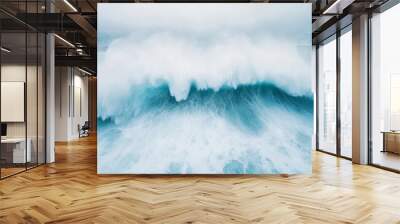 A powerful ocean wave crashing, symbolizing the raw energy and force of nature. Wall mural