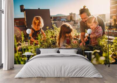 Young family, one parent and three children, gardening on their rooftop Wall mural