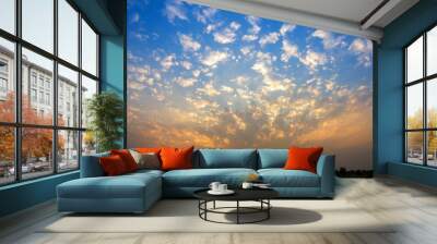 Beautiful fluffy clouds with evening sunset background. Wall mural