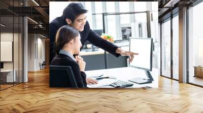 Happy of businesswoman and businessman partners discussing positive adult business working together with computer on wooden table and ideas at meeting in office background. Wall mural