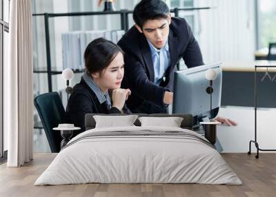 Stressed of businesswoman and businessman partners discussing positive adult business working together with computer on wooden table and ideas at meeting in office background. Wall mural