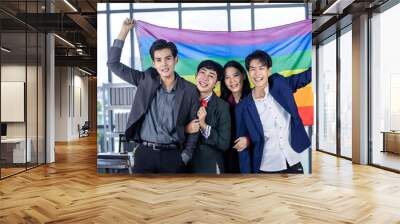 Successful company with happy workers Group of asian business people with diverse genders (LGBT) celebrate LGBT freedom and support with LGBT flag in the meeting room at office Wall mural