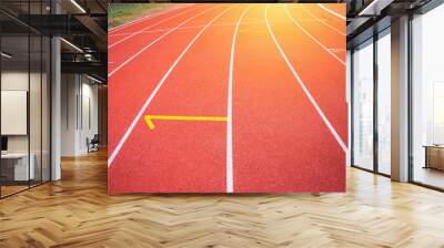 White lines of stadium and texture of running racetrack red rubber racetracks in outdoor stadium are 8 track and green grass field,empty athletics stadium with track,football field, soccer field. Wall mural