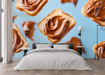 Deliciously floating slices of bread topped with creamy chocolate spread on a bright blue background Wall mural