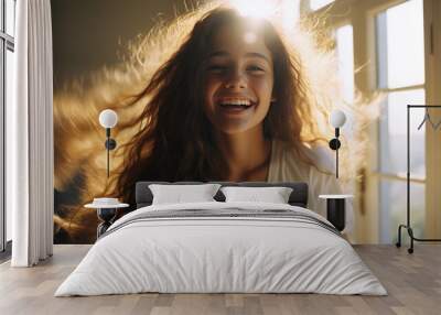 energetic teenager with brown voluminous hair smiling at home, photo of a young girl full of joy of life Wall mural