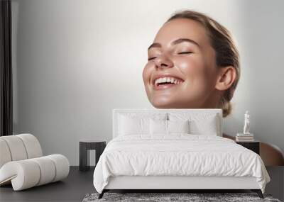 joyful woman with closed eyes showcasing a radiant smile for a skincare advertisement, perfect skin, cosmetics mockup, face turned to the left on a white background Wall mural