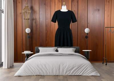 Black wool shift dress with short sleeves and pleated waist display on aesthethic wood wall background Wall mural