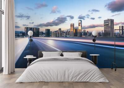 asphalt road with city skyline Wall mural