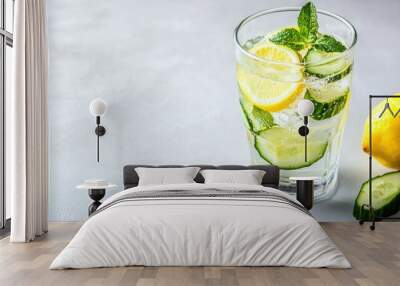 A glass of detox water with lemon, cucumber, and mint on a white surface, with copy space beside. Wall mural