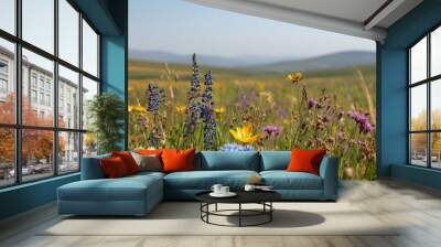 Close-up of wildflowers in a European meadow, with rolling hills and clear sky for copy space Wall mural