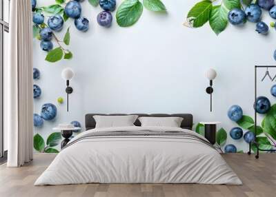 Delightful border frame of fresh and juicy blueberries with lush green leaves on a white background showcasing their natural beauty and fine details Wall mural