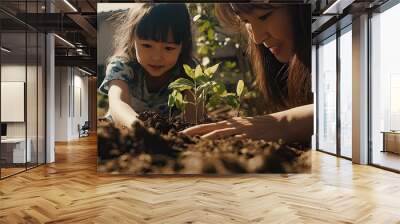 an Asian girl planting trees with her mother Wall mural