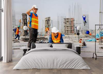 Engineers oversaw the construction site skyscraper. Wall mural