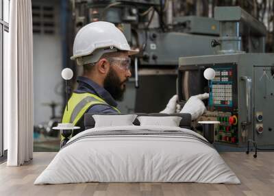 Engineering manager and mechanic worker check up in industrial factory. Professional technician using computer in an industrial factory Wall mural