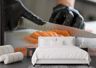 Japanese Chef preparing a fresh salmon fillet in kitchen. Close up hand of chef with salmon sashimi. Wall mural