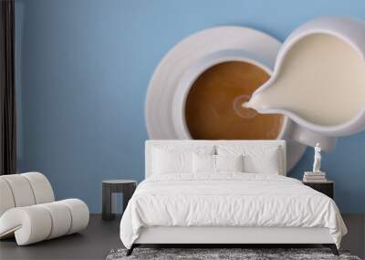 pouring milk from small ceramic pitcher into a cup of coffee Wall mural