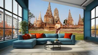 woman in Thai traditional costume with ancient pagoda at temple at Ayutthaya, Thailand (Wat Chai Wattanaram) Wall mural