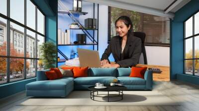 Asian business woman happily working at office Wall mural