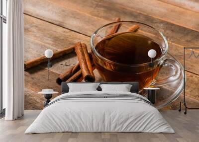 a cup of cinnamon tea on wooden table Wall mural