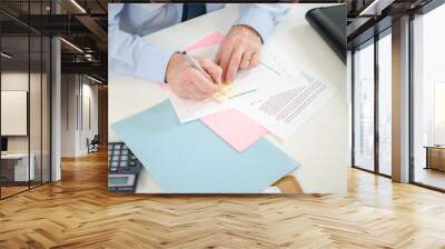 Businessman taking a note on a post it Wall mural