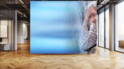 Elderly woman having headache; panoramic banner Wall mural