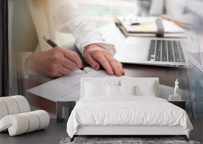 Hand of businesswoman signing a document (lorem ipsum text used); multiple exposure Wall mural