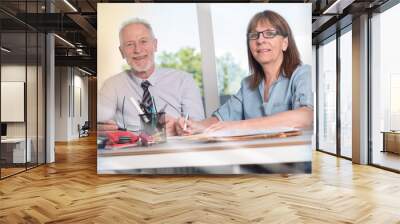 portrait of two business people working together; multiple exposure Wall mural