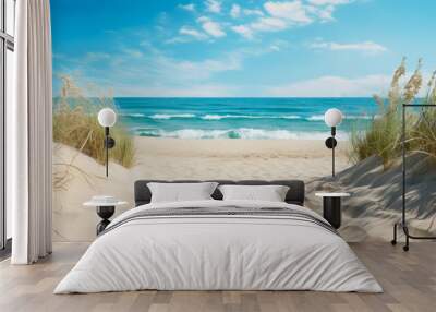 Sand dunes on the beach with blue sea and sky background. Wall mural