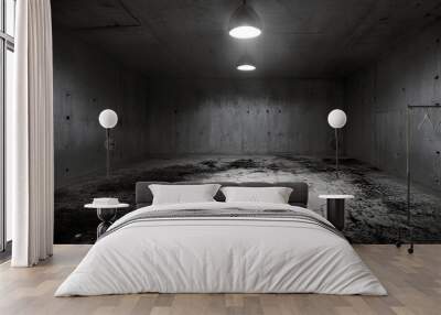 Empty concrete room, dimly lit by two pendant lights.  Rough, textured walls and floor add to the desolate atmosphere.  A feeling of loneliness pervades the space. Wall mural