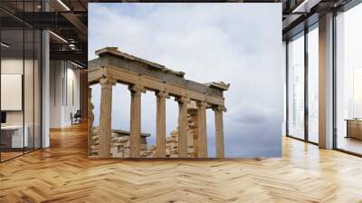 Columns and marble remains of the mighty Parthenon on the hill of the Acropolis in Athens, sacred temples of the goddess Athena and tutelary goddess of the city - sightseeing and vacation in Greece Wall mural