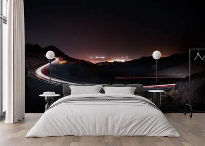 highway long exposure vehicle light trails curvy highway between mountains at starry night  Wall mural