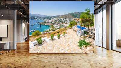 Beautiful sunny village town harbor view to the greek blue sea with clear water with boats cruising surrounded by hills mountains, Panteli, The View, Leros, Dodecanese Islands/ Greece – July 21 2017 Wall mural