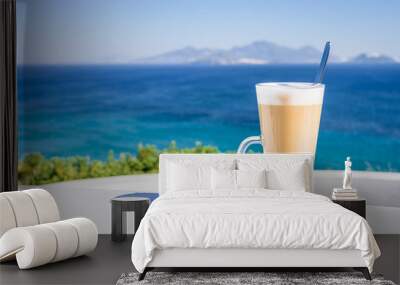 Cold greek coffee frappe latte macchiato cappuccino with ice cream standing on a table time for a holiday break, in the background palm trees and some yacht cruising in sea, Kos Island, Greece Wall mural