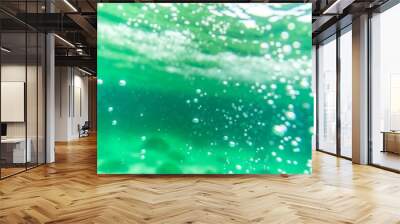 Bubbles and bokeh underwater in clear green ocean Wall mural