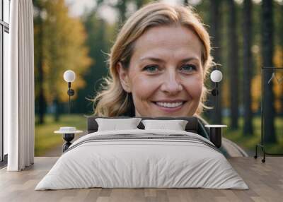 Close portrait of a smiling 40s Finnish woman looking at the camera, Finnish outdoors blurred background Wall mural