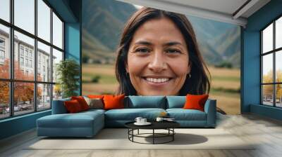 Close portrait of a smiling 40s Peruvian woman looking at the camera, Peruvian outdoors blurred background Wall mural