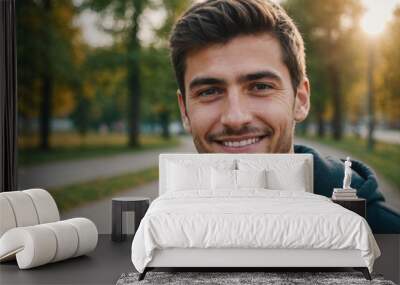 Close portrait of a smiling young Bulgarian man looking at the camera, Bulgarian outdoors blurred background Wall mural