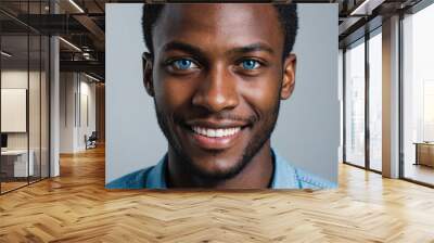 Full framed very close face portrait of a smiling young african man with blue eyes looking at the camera, studio shot. Wall mural