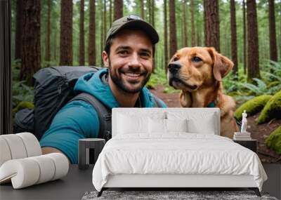 Happy Male hiker taking selfie through smart phone with dog at forest Wall mural