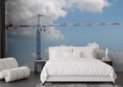 two high cranes on blue cloudy sky background Wall mural