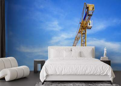 yellow crane on blue sky background Wall mural