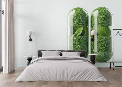 Two clear capsules filled with green granules and leaves sit on a white surface Wall mural