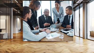 Discussion, planning and business people with laptop in office for financial review, strategy and collaboration. Meeting, teamwork and men and women working on report, group project and proposal Wall mural