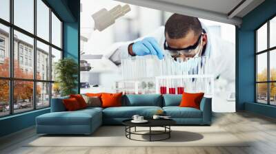 Smart looking scientist working with blood sample, DNA testing or virus research in a lab. Black male science or biology expert analyzing test tube for disease or medical innovation in a laboratory Wall mural