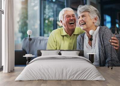 When youre laughing, youre living. Shot of a happy senior couple relaxing together on the sofa at home. Wall mural