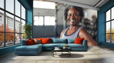 Smiling senior woman in a gym Wall mural