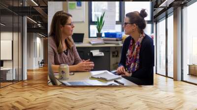 Two women having a serious conversation in an office Wall mural